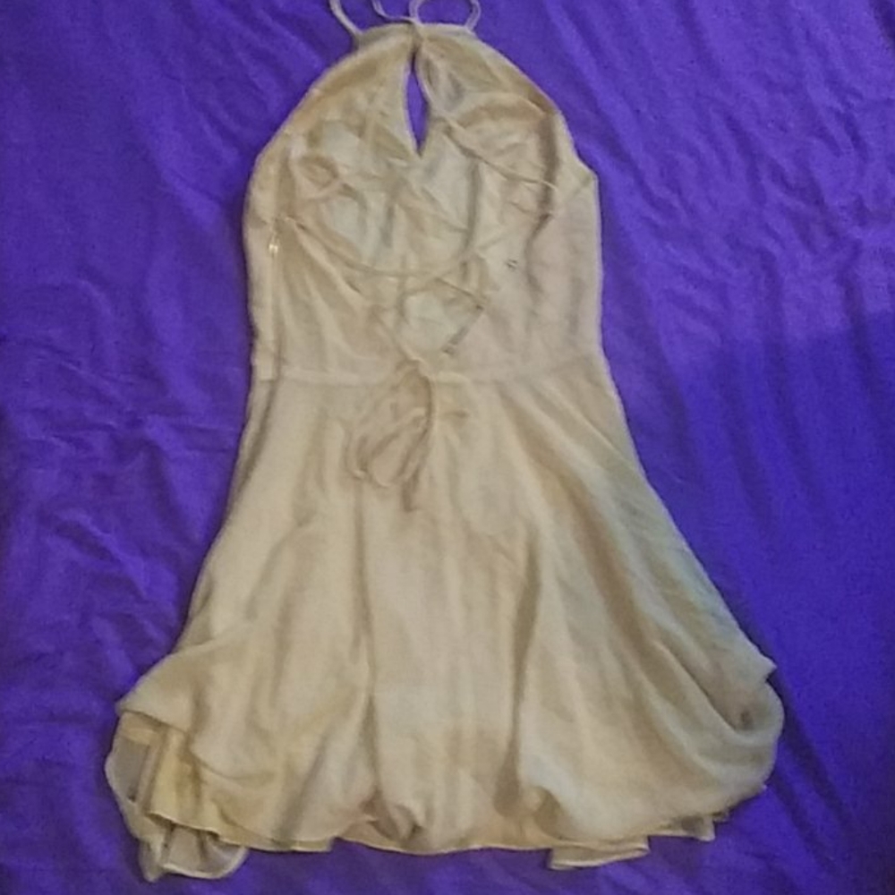 A yellow bebe mini dress, laces up in the back